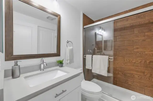 Fresh and new!  New cabinet, with slow close drawers.  New Quartz Countertop.  New seed glass light fixture.  New Kohler toilet, new fan in bathroom and adjoining laundry space.  Wow Factor continues!