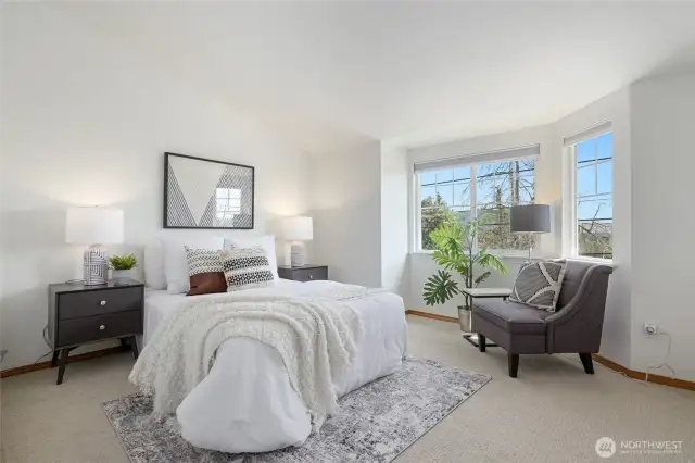 The primary bedroom has east facing windows and view of the Cascades.
