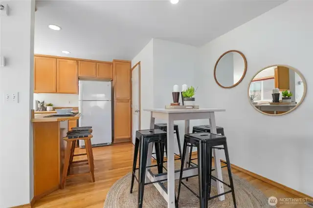 Spacious great room has space for a dining table and there's a breakfast bar in the kitchen, too.