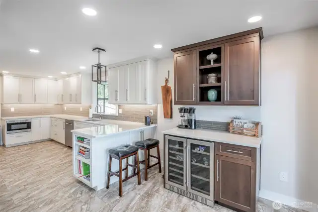 Beautiful and spacious updated kitchen with quartz countertops and full height backsplash and beverage refrigerator's