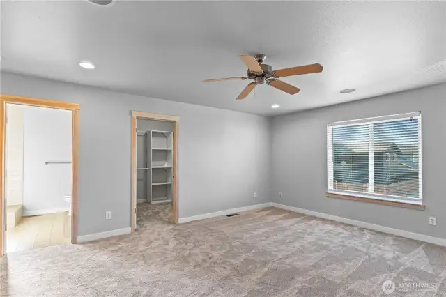 primary bedroom looking into walk-in closet and on-suite bath