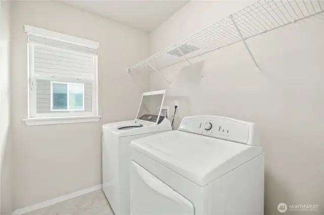 Convenient upstairs laundry room with extra space