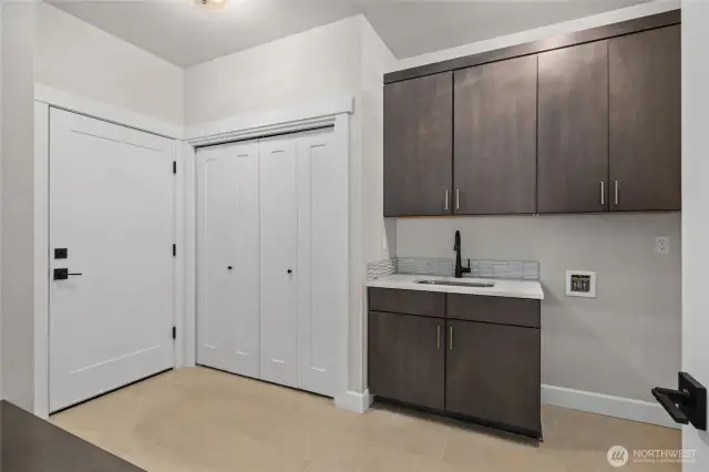 Large laundry room with utility sink.