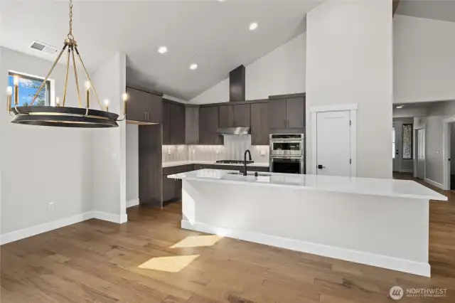 Solid quartz countertops and full height backsplash