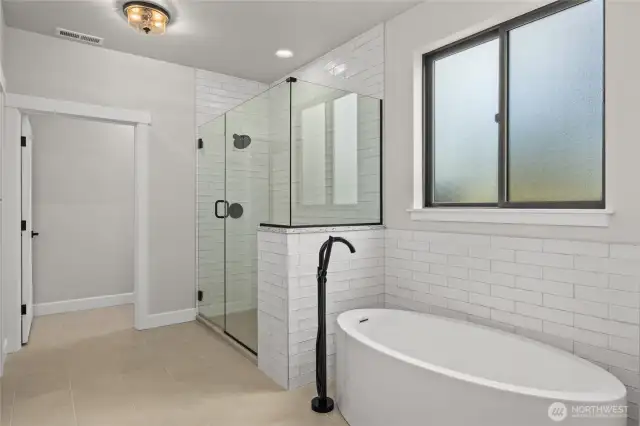 Beautiful tile work around tub and shower enclosure.