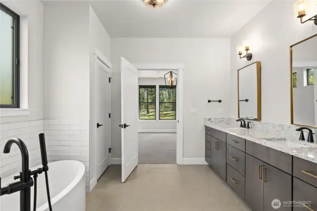 Five piece primary bath featuring solid countertops with undermount sinks.