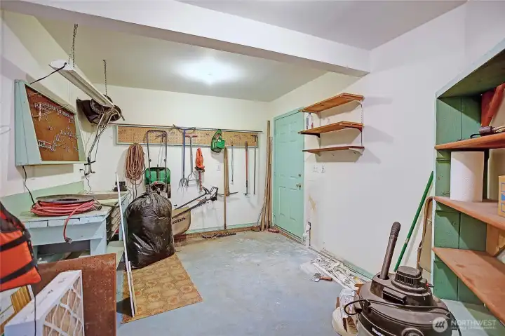 Storage room in basement with door to the back patio