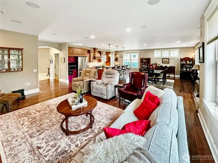 The gathering room with engineered hardwood floors, can lighting, gas fireplace and surround speaker system.