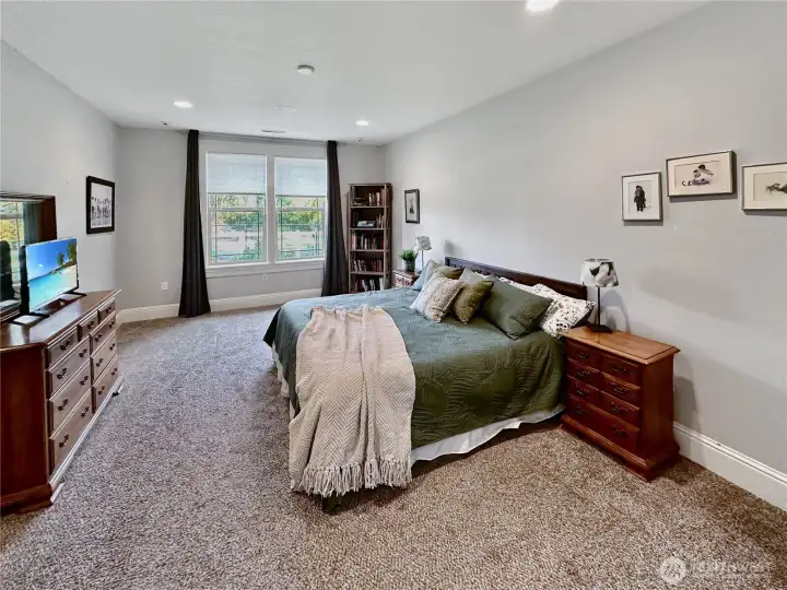 Spacious primary bedroom with views of the rear yard and canal.