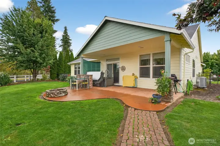 Backyard features include the covered area with hot tub, extended patio for outdoor furniture, garden space and fenced rear yard with gate to the community walking trail.