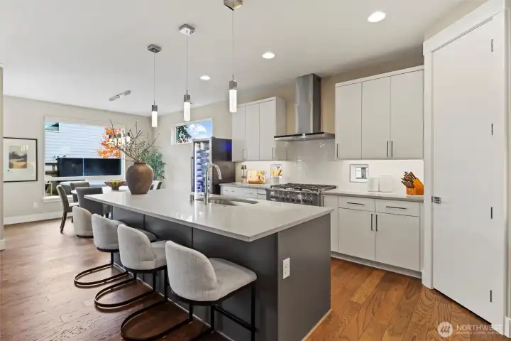 Chefs kitchen with oversized Quartz Island, Huntwood sleek cabinetry, Fisher & Paykel appliances and walk-in pantry.