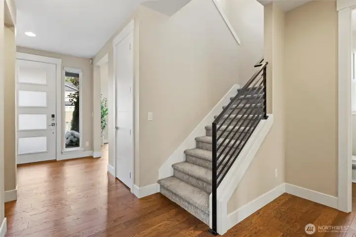 Modern railing with freshly cleaned carpets leading up to spacious second floor.