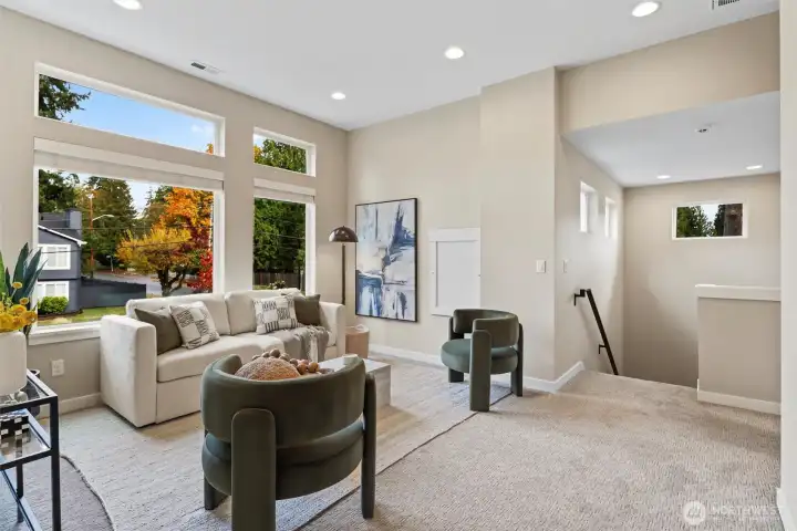 Loft area with flexibility for additional living space. Grand 10 ft ceilings and custom mounted TV.