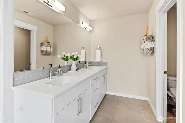 Spa inspired primary bath with large shower, soaking tub, and grand walk-in closet.