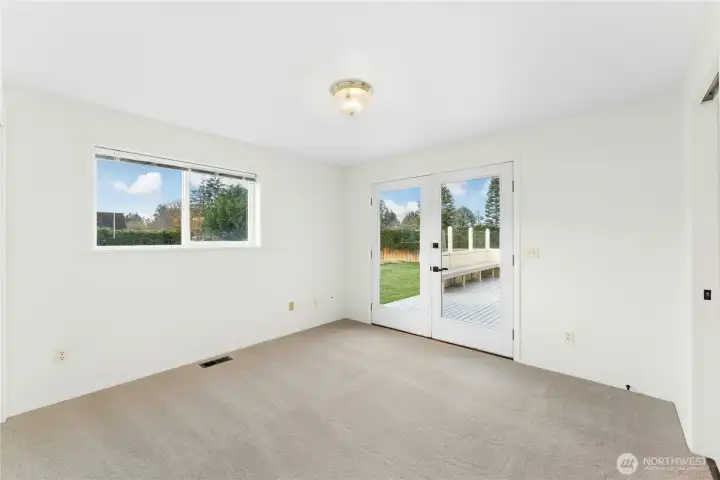 2nd bedroom featuring French doors that open to the deck.