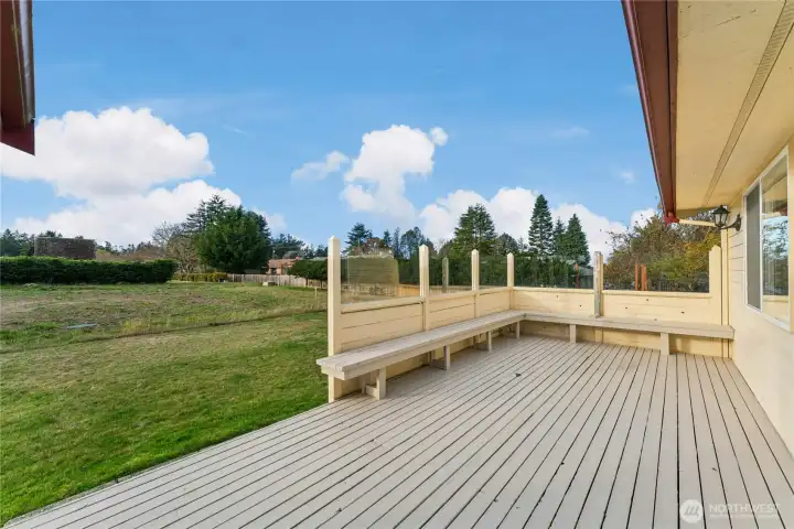 Spacious deck with built-in seating, ideal for entertaining.