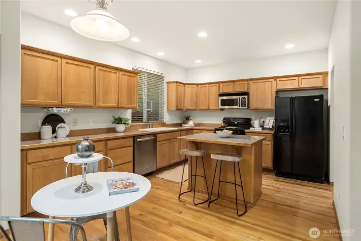 Kitchen with breakfast bar and eating area.