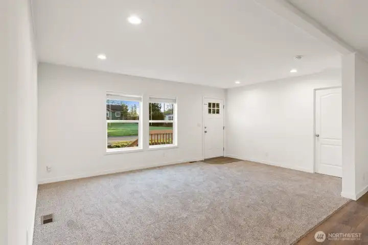 Large light filled living room.  Door to the right in the picture leads to the primary bedroom.