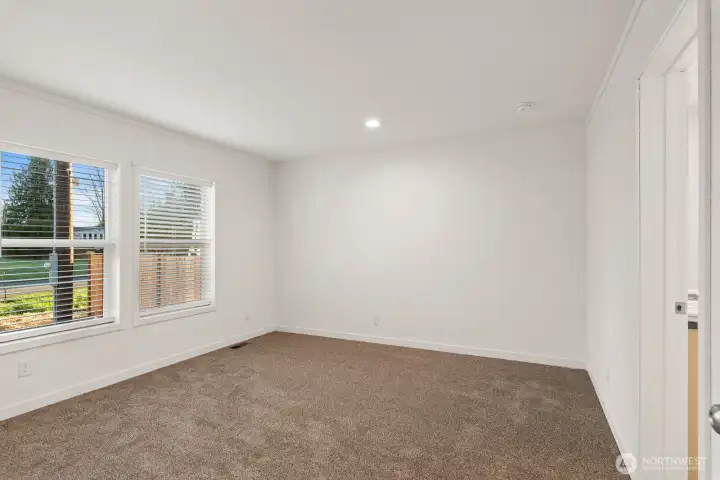 The house has perfect space separation as the primary bedroom with double windows is on the opposite side of the house from the other two bedrooms.