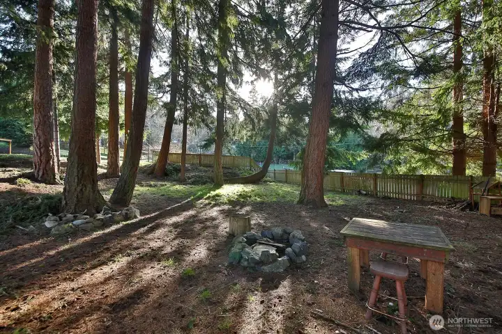 A favorite aspect of this property is the grove of firs and cedars, a mini-forest adjacent to your sunny lot! Fire pit and plenty of space to hang a few hammocks.