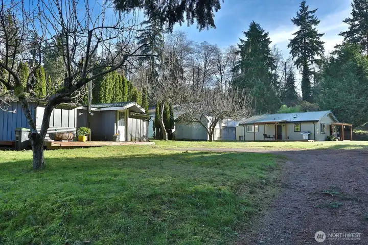 This is the view as you are entering the driveway of the Guest House (off of Sunlight Drive). The fir grove is to the right edge of this photo. Let's go check out the clubhouse and beach (located at the end of Evening Glory on the other side of Bayview Road).