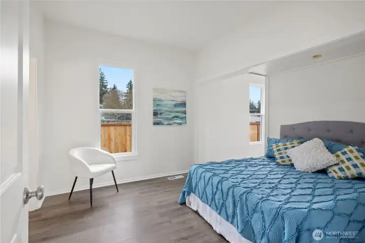 Main floor primary bedroom with attached primary bath.