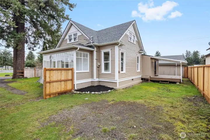 Backside of home, includes new fencing and covered back deck.