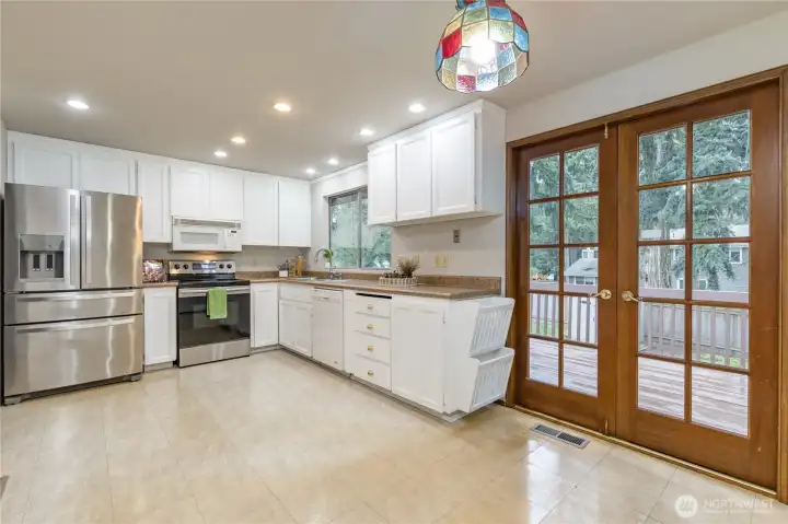 Breakfast nook has French doors opening to the expansive back deck