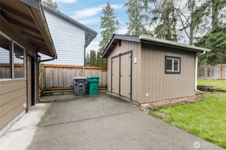 Large shed with power. Garage includes workbench, 220V outlets and its own furnace!