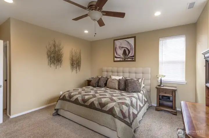 Another view of the primary suite There is a ceiling fan, but this home also has a newer HVAC system, including AC.