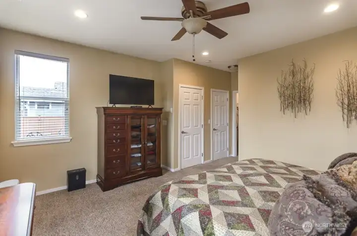 This view of the primary bedroom shows you the entry and side window that looks out to the back yard.
