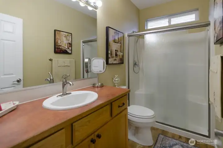 Primary bath has an expanded walk-in shower with a bench.