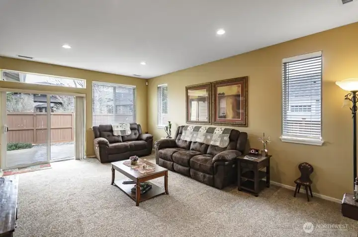 Another view of the living room showing the slider that leads to the back deck and access to the fenced yard.  There is no home directly behind this house, only the Lodge parking lot.