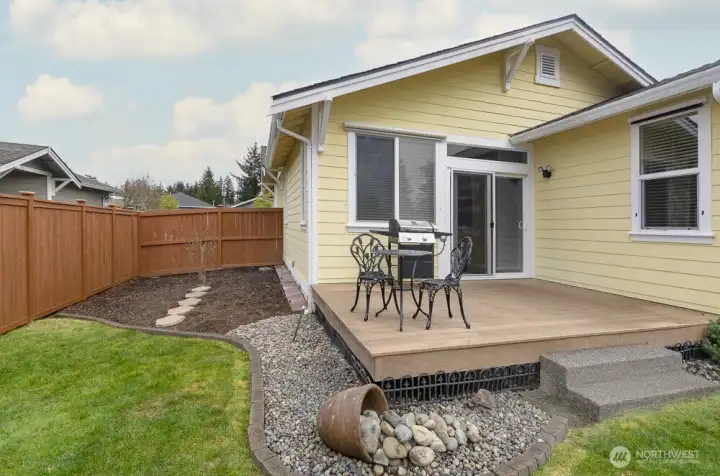 Deck off back slider is ready for outdoor dining or entertaining.   The extra wide side yard is unique to this community.  It receives lots of sun throughout the day, making it a perfect place for a garden.