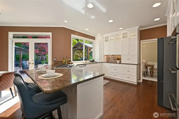 Plus bar seating with French Doors that open perfectly to the resort-like backyard.