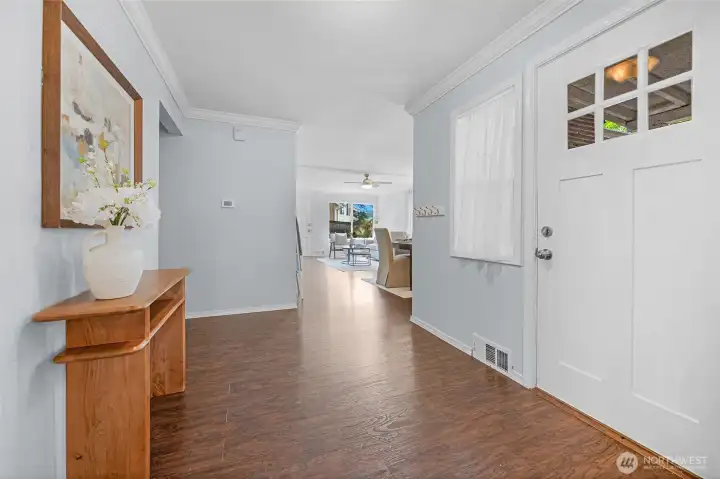 A welcoming first impression! This bright entry foyer offers plenty of space to greet guests, beautiful flooring, and a seamless view straight through to the main living areas.