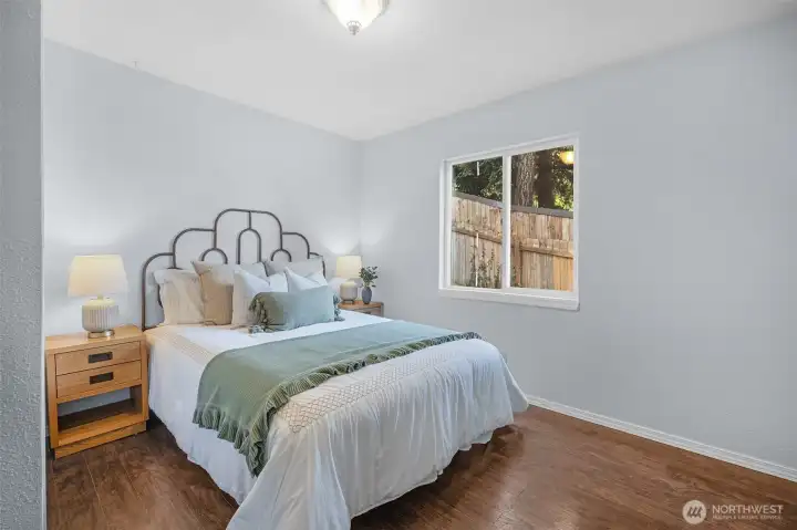 Desirable main floor primary bedroom, fresh neutral paint, and a large window bringing in plenty of natural light.