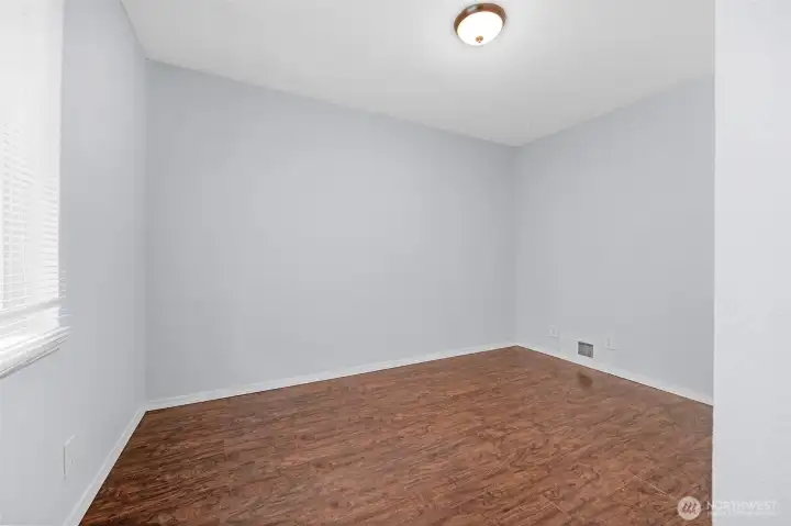 Another convenient main floor bedroom! Low-maintenance hard-surface floors, and a versatile layout ready for your personal touch.