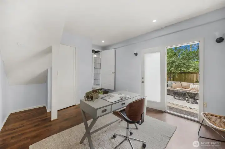 Incredible attached office or studio space boasts a separate entrance, rich hard-surface flooring, and private patio access. The ultimate flexible space to fit your needs!