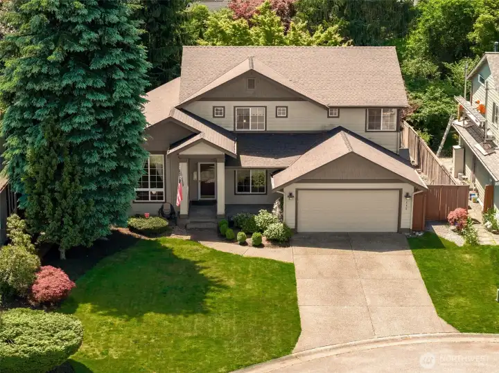 A darling front lawn and easy to maintain plants add to the curb appeal. Check out the long driveway!