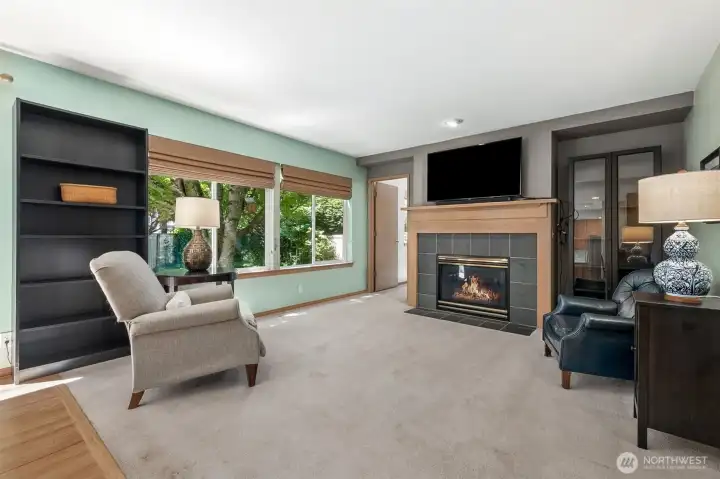 Living Room with a cozy fireplace sits along side the back yard for peach and quiet!