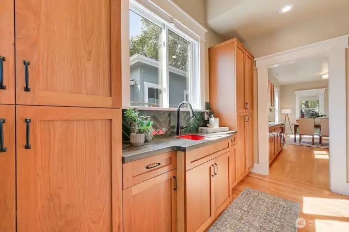 Butler's pantry with sink and custom cabinetry.