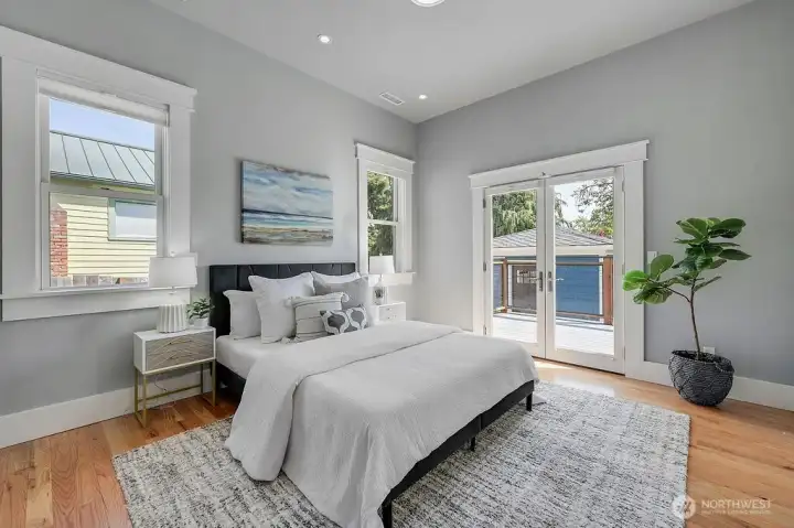 Access to the back deck through the French doors off the primary suite.