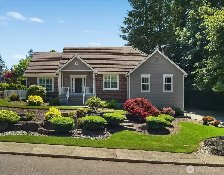 Mature, established landscaping creates striking curb appeal and a programable sprinkler system allows for ease of care. Mature, established landscaping creates striking curb appeal and a programable sprinkler system allows for ease of care.