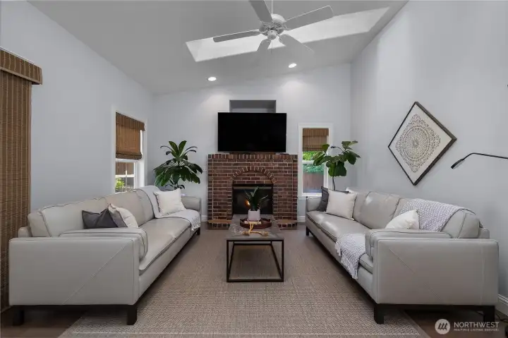 The family room feels bright and airy with the addition of skylights, vaulted ceilings, and a ceiling fan while the brick gas fireplace provides warm comfort. The family room feels bright and airy with the addition of skylights, vaulted ceilings, and a ceiling fan while the brick gas fireplace provides warm comfort.