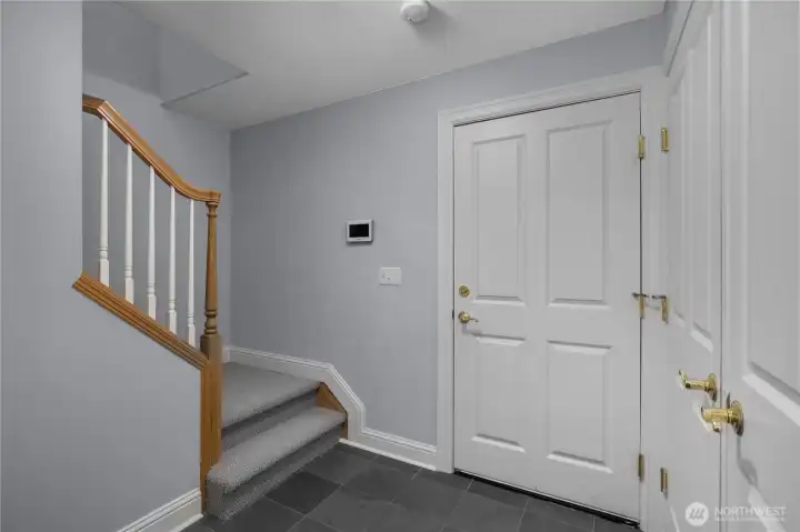 Door to the three-car garage and area for mud room with more storage behind double doors Door to the three-car garage and area for mud room with more storage behind double doors