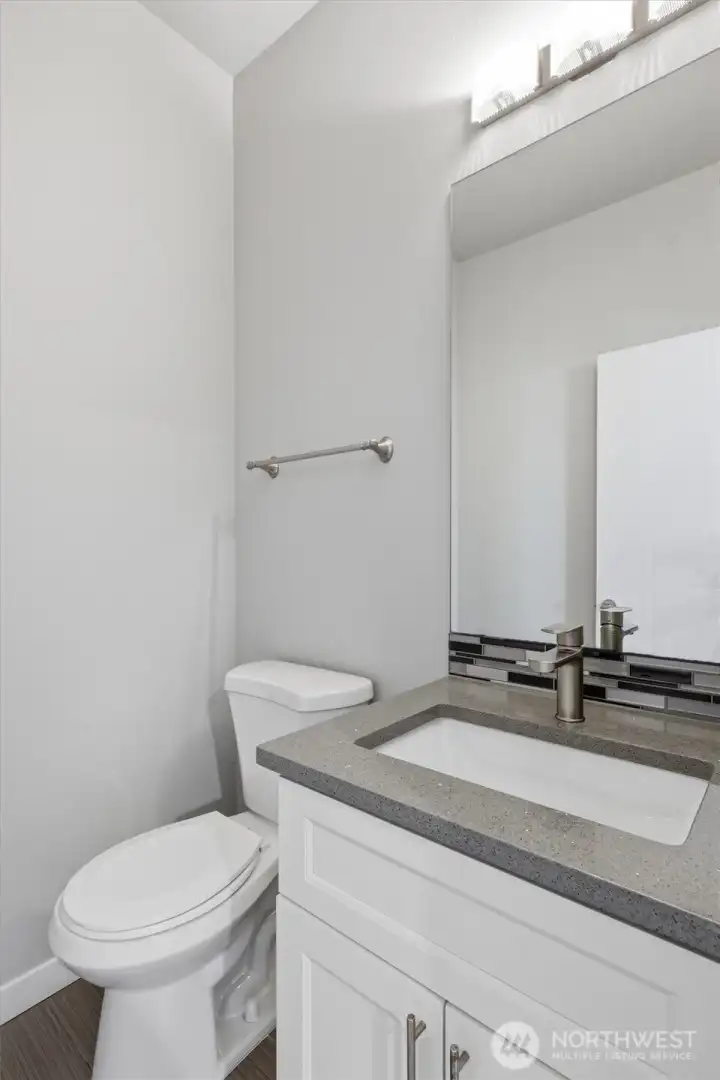 Convenient main floor powder room tucked perfectly out of the way.