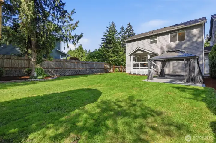 Wide open lawn space gives this backyard such a peaceful feel.