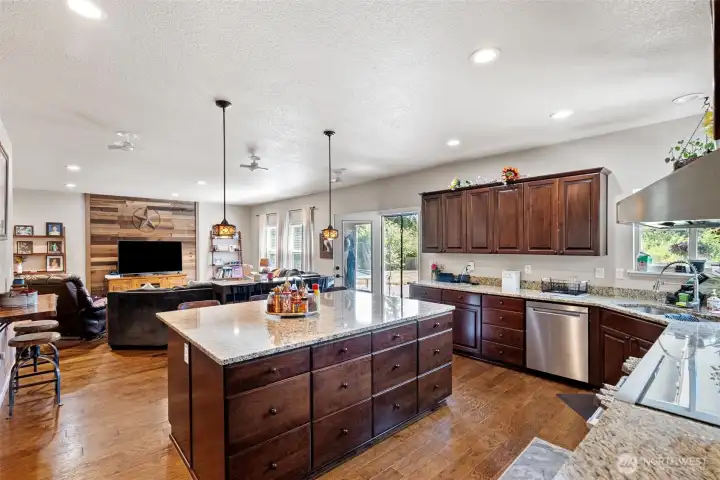 Open kitchen with high efficiency induction range, huge island and lots of counterspace.