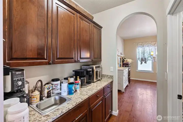 Pass through arched doorways to the Butler's panty with sink and Walk-in pantry on the right.